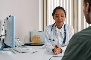 Black female doctor consulting with a patient in a medical office