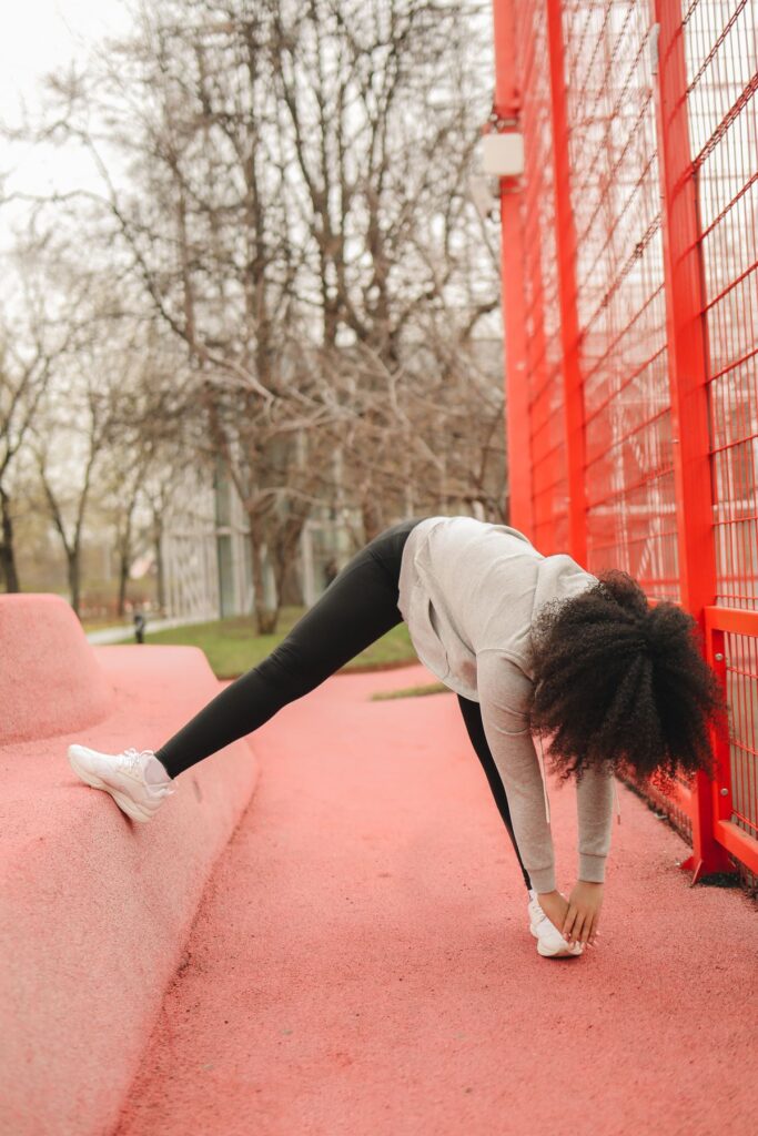 Woman stretching outdoors in a park, active lifestyle