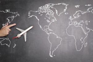Toy airplane over a world map, representing medical tourism to Abuja